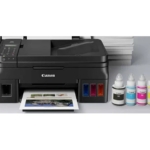 A Canon Pixma G2410 3-n-1 ink-tank printer with refillable ink bottles ready for printing ,copying and scanning
