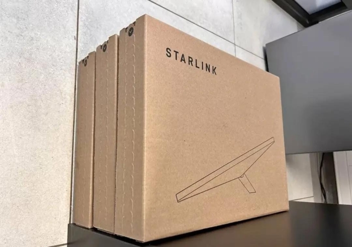 A Starlink satellite internet kit with dish, router, and cables for high-speed connectivity.